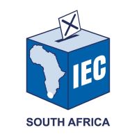 Blue ballot box with "IEC" and outline of African continent, South Africa highlighted. Ballot being inserted into slot of ballot box.